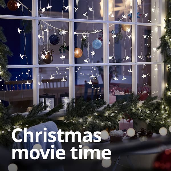 A lifestyle image of a home exterior well decorated with Christmas lighting and garlands. 