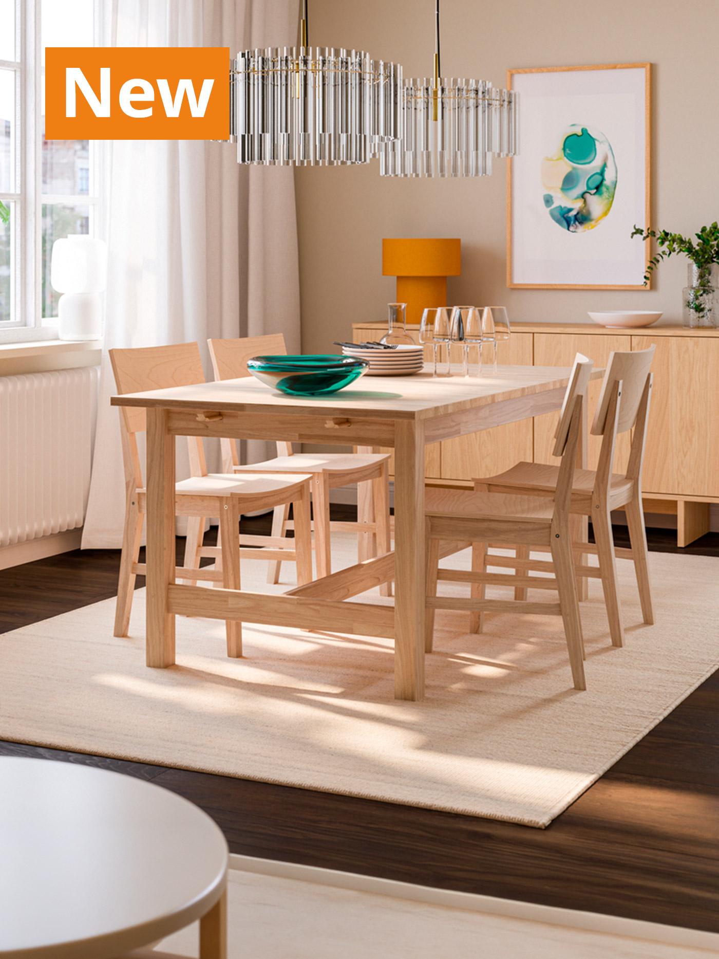 A lifestyle image of dinning room setting with KARSKÄR table and chairs in rubberwood material. Overlaying the image, orange tag that reads 'New' on the top left corner.