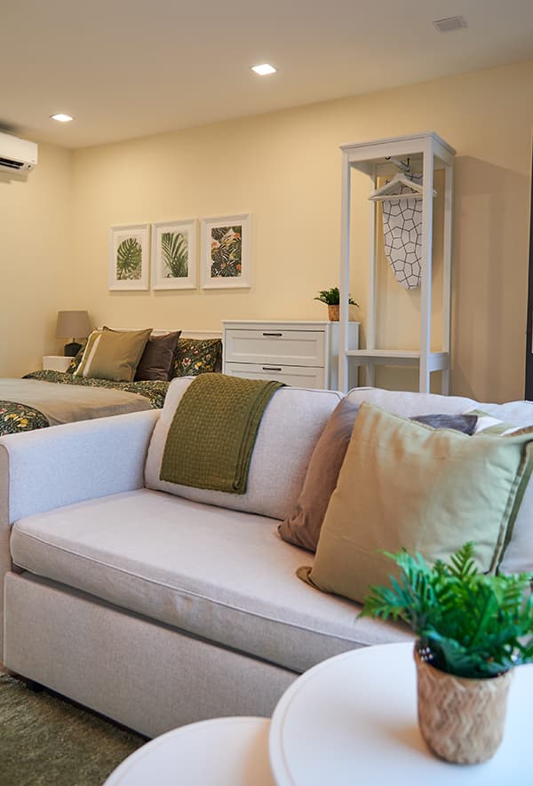 A light beige sofa with a small white table in front.