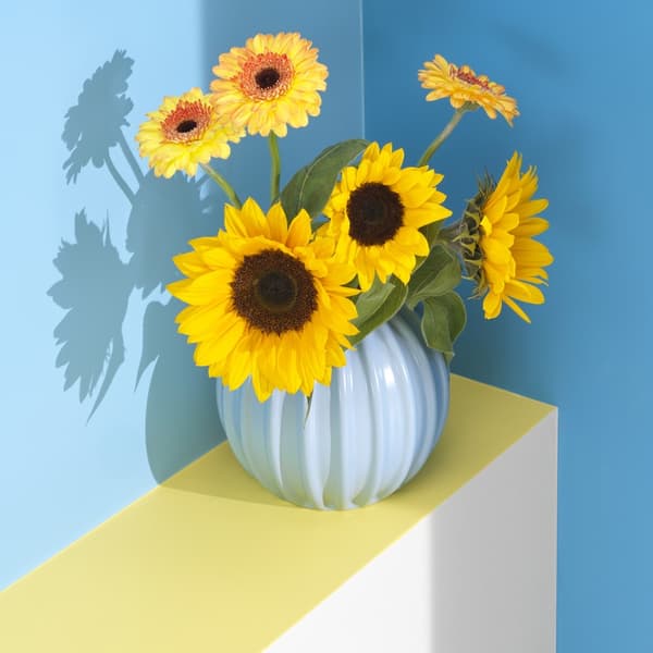 A light blue SKOGSTUNDRA vase