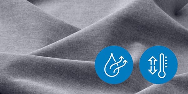 A light grey fabric with symbols enclosed in a blue circle. The 2 circles are a Thermometer with an arrow pointing up and down and 2 arrows passing out of a water droplet