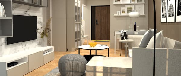 A living room filled with IKEA furniture. A BESTA TV bench is placed below a TV, which is attached to a white marble wall. A grey SANDARED pouffe is placed in front of a TV on a rug.