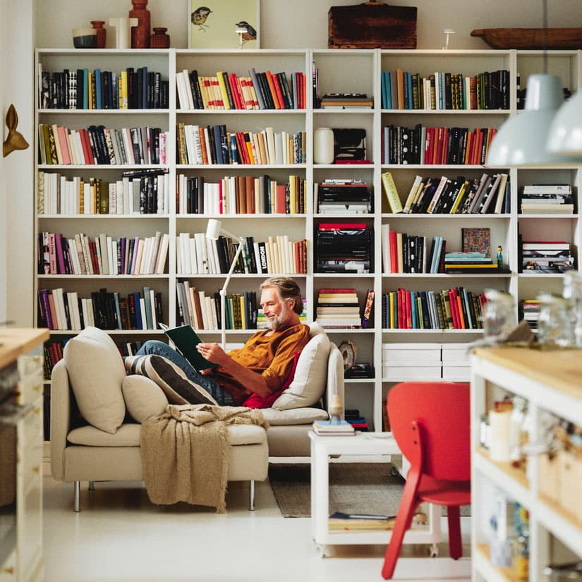 A living room interior with BILLY bookcases standing in the background. 