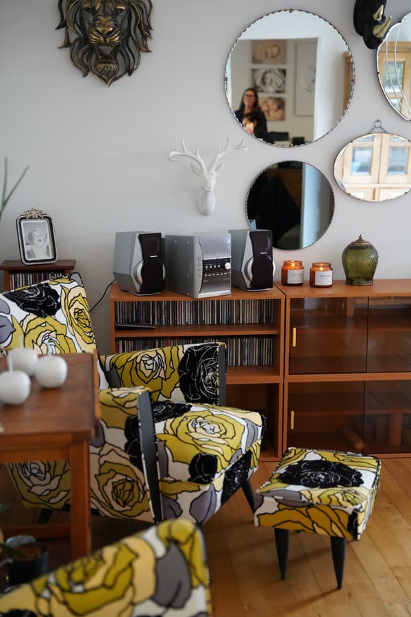 A living room with sentimental items and an armchair.