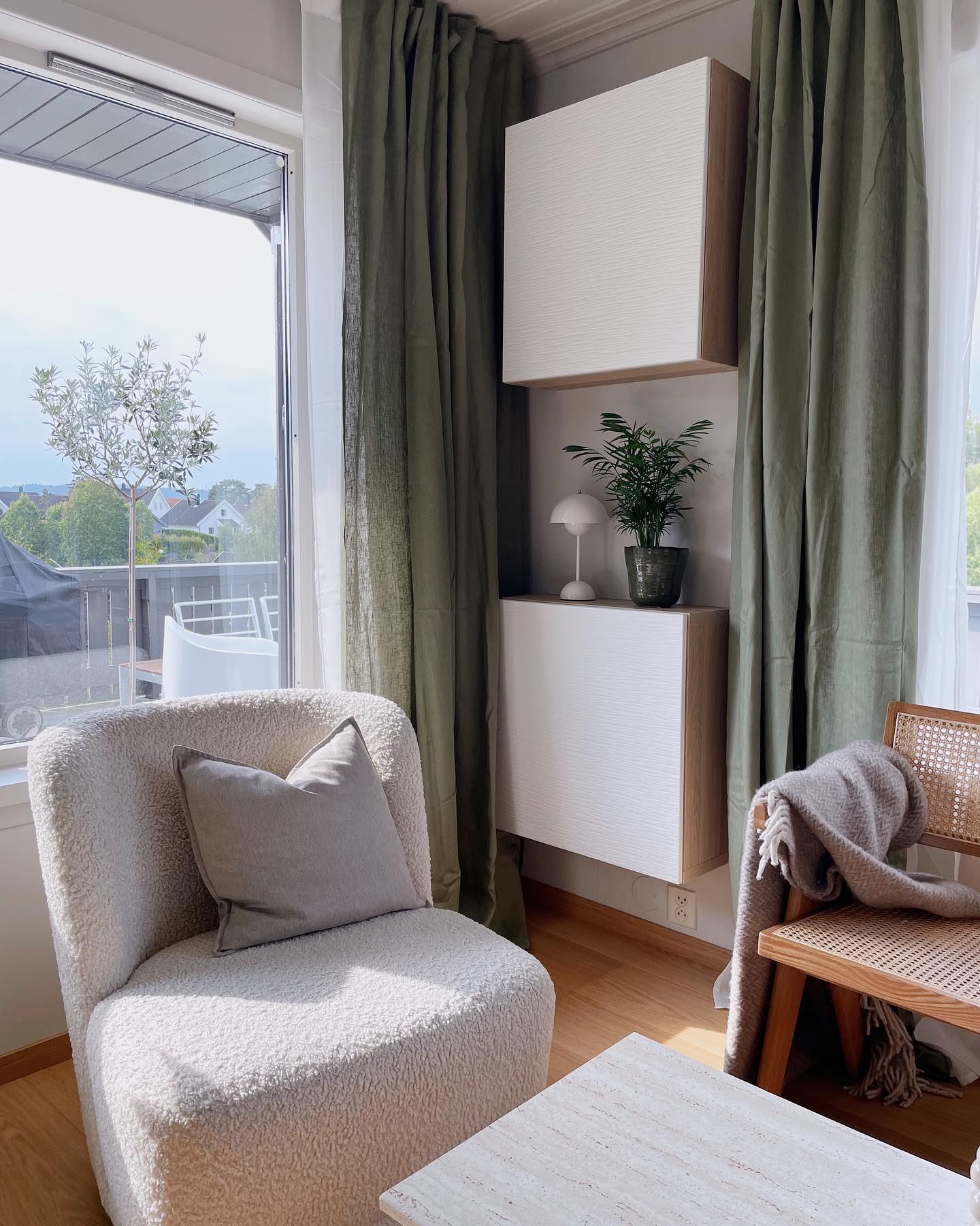 A living room with two BESTÅ units mounted one above the other.