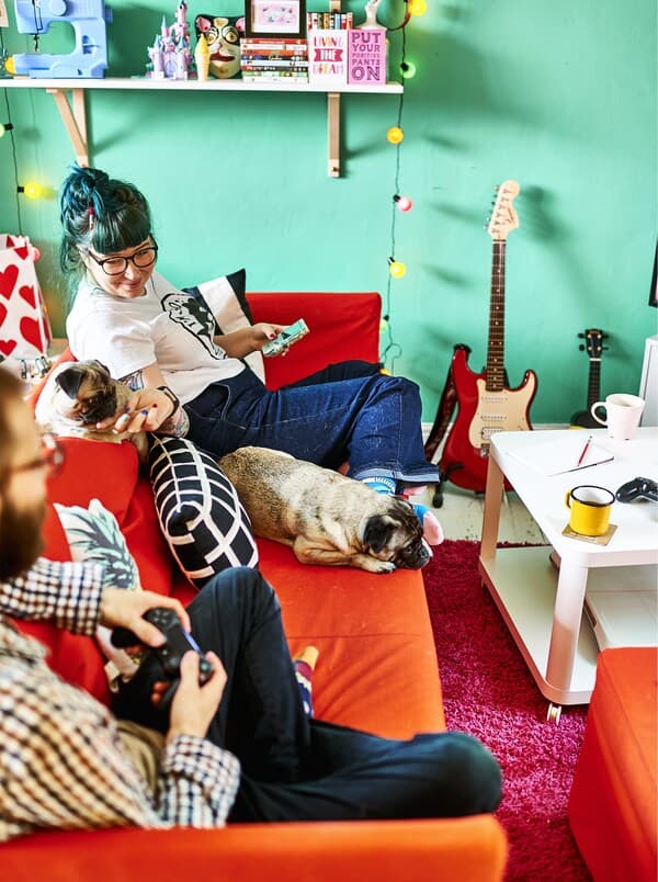 A loft room with an orange sofa and bright wall.