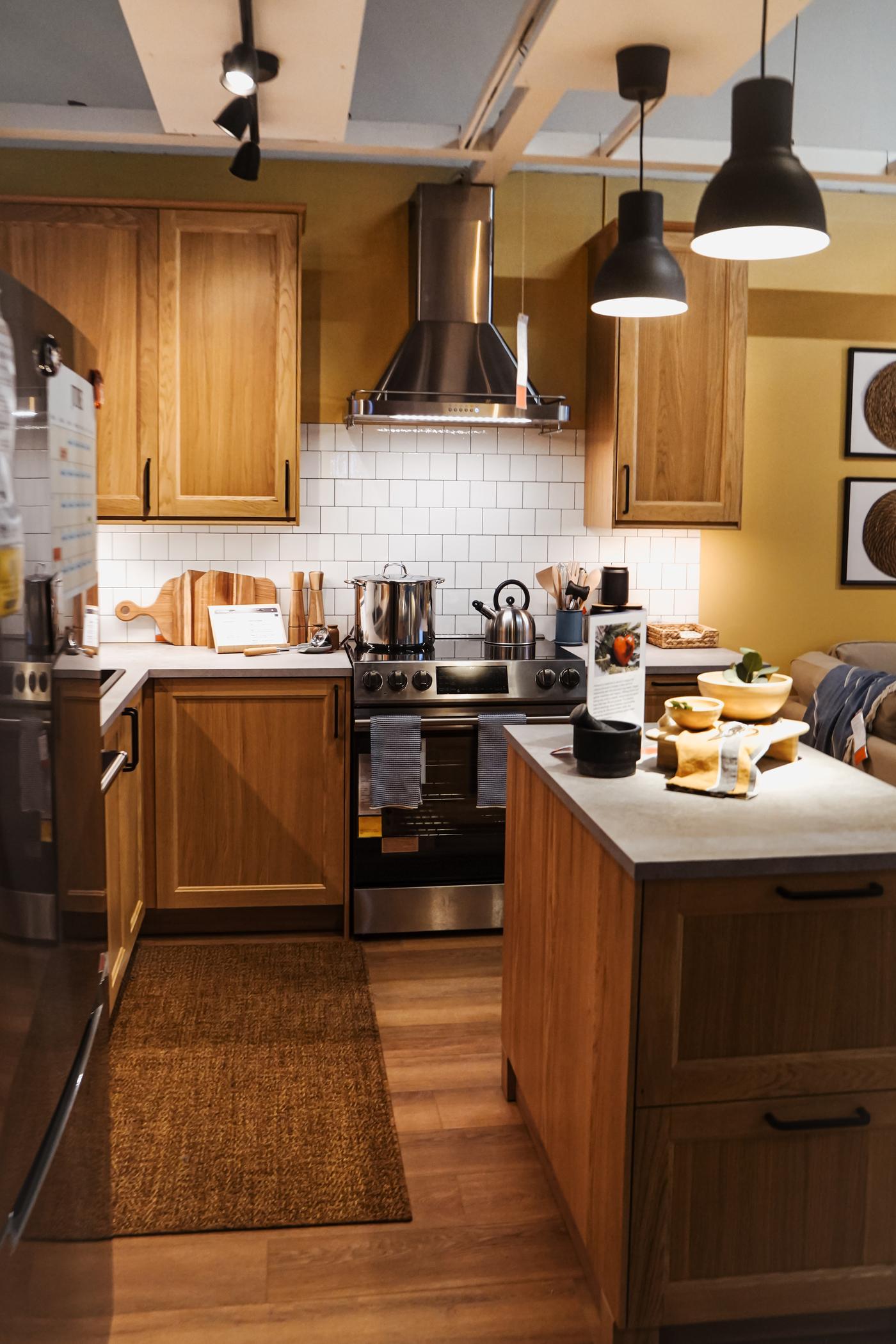A long shot of a kitchen room setting in an IKEA store.