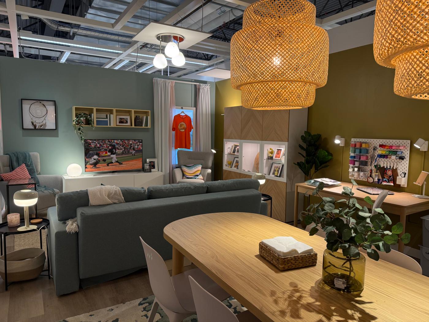 A long shot of a room setting in a store outfitted with furniture and accessories.