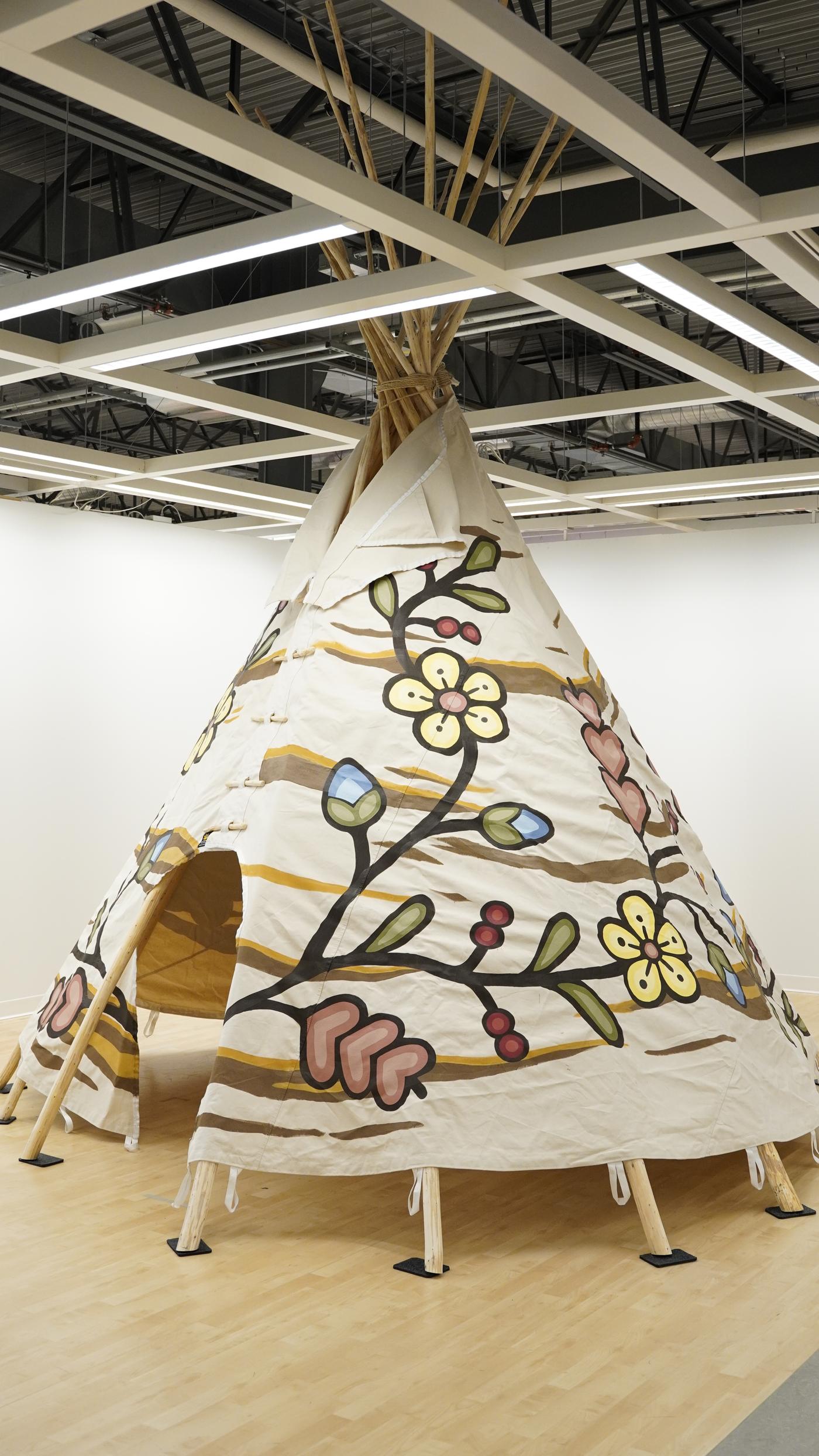 A long shot of a tipi set up in a store.