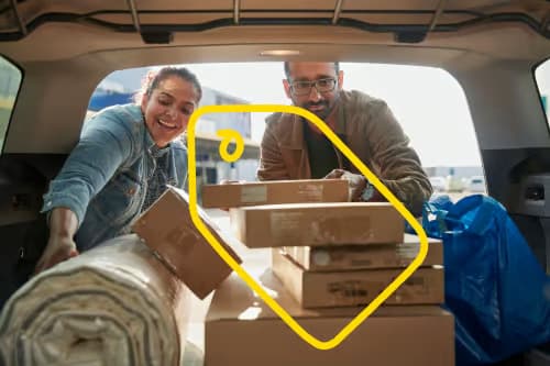 A man and a woman put new IKEA products in their car