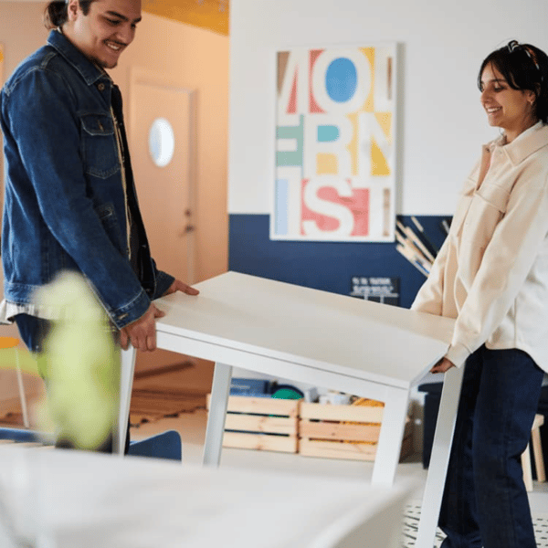A man and woman holding a white table