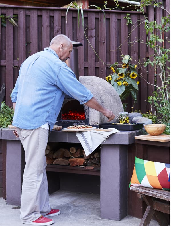 A man cooking at the barbecue.