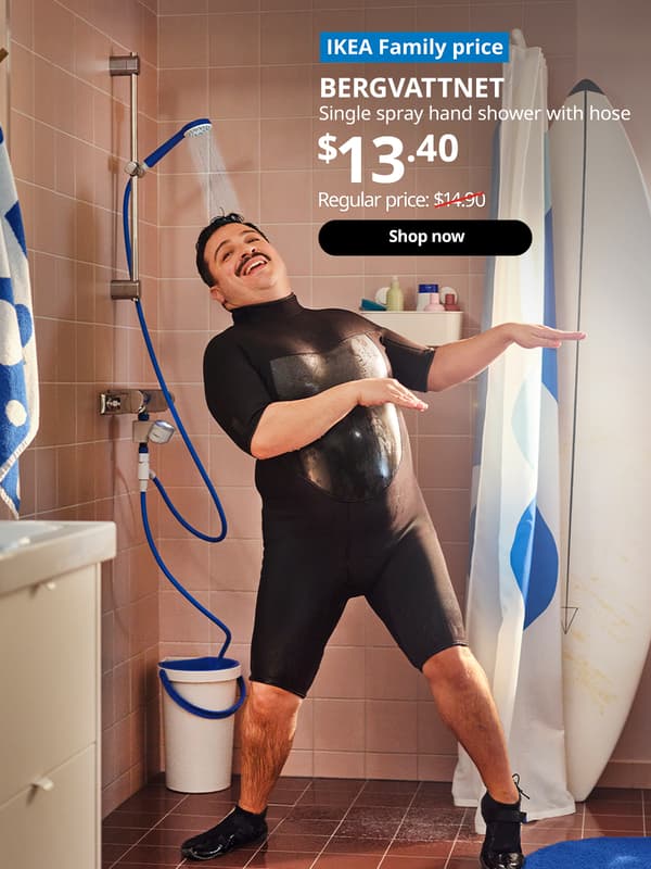 A man dancing in the shower while the water is running from the BERGVATTNET single spray hand shower with hose. White text of blue tag that reads "IKEA Family price". White text over image that reads "BERGVATTNET, Single spray hand shower with hose. Price $13.40. Regular price: $14.90 with red line slashed across.