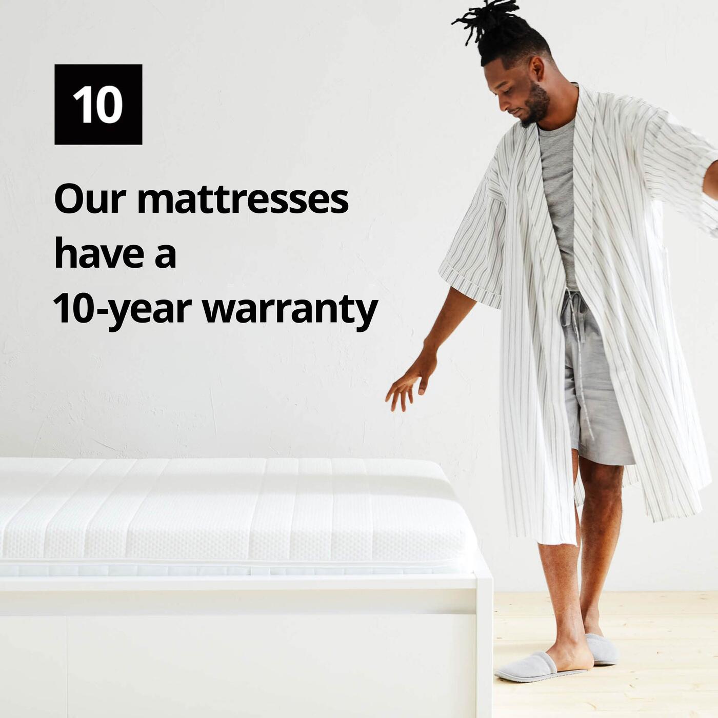 A man in a bathrobe stands next to a mattress and a graphic symbol with the number 10 and the text "Our mattresses have a 10-year limited warranty" on the image.