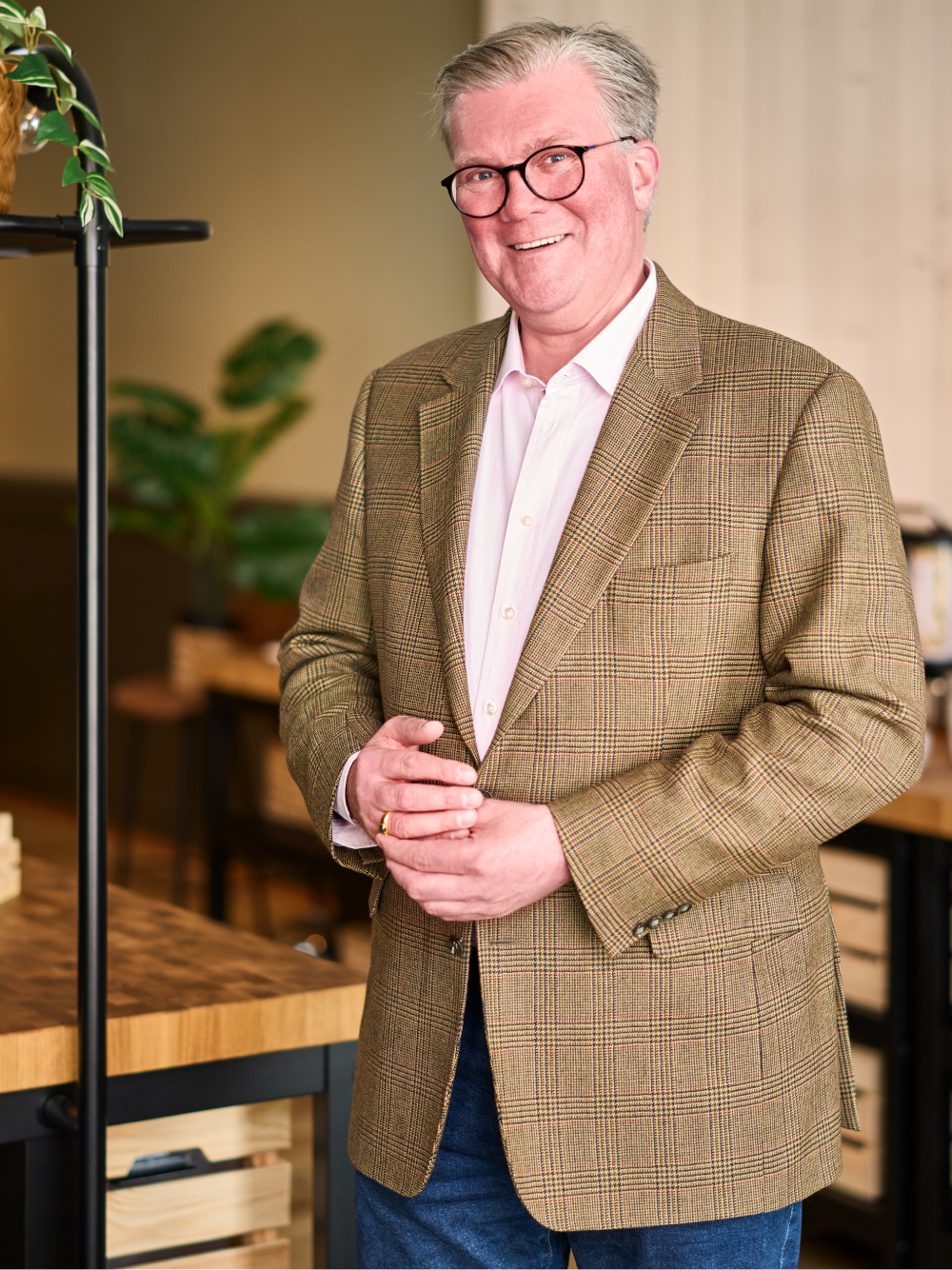 A man in a suit smiling at the camera