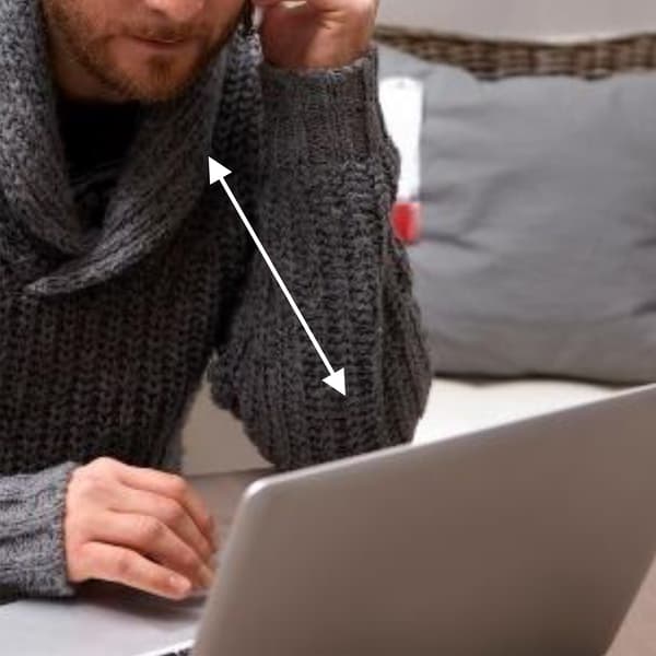 A man looking at the laptop.