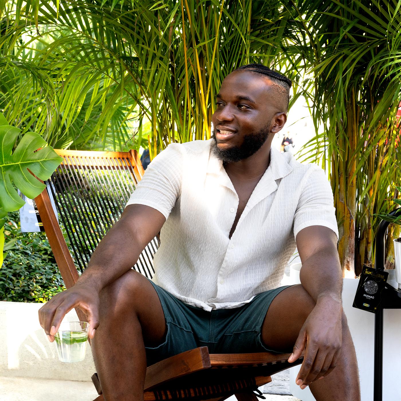 A man sitting in a chair under a tree