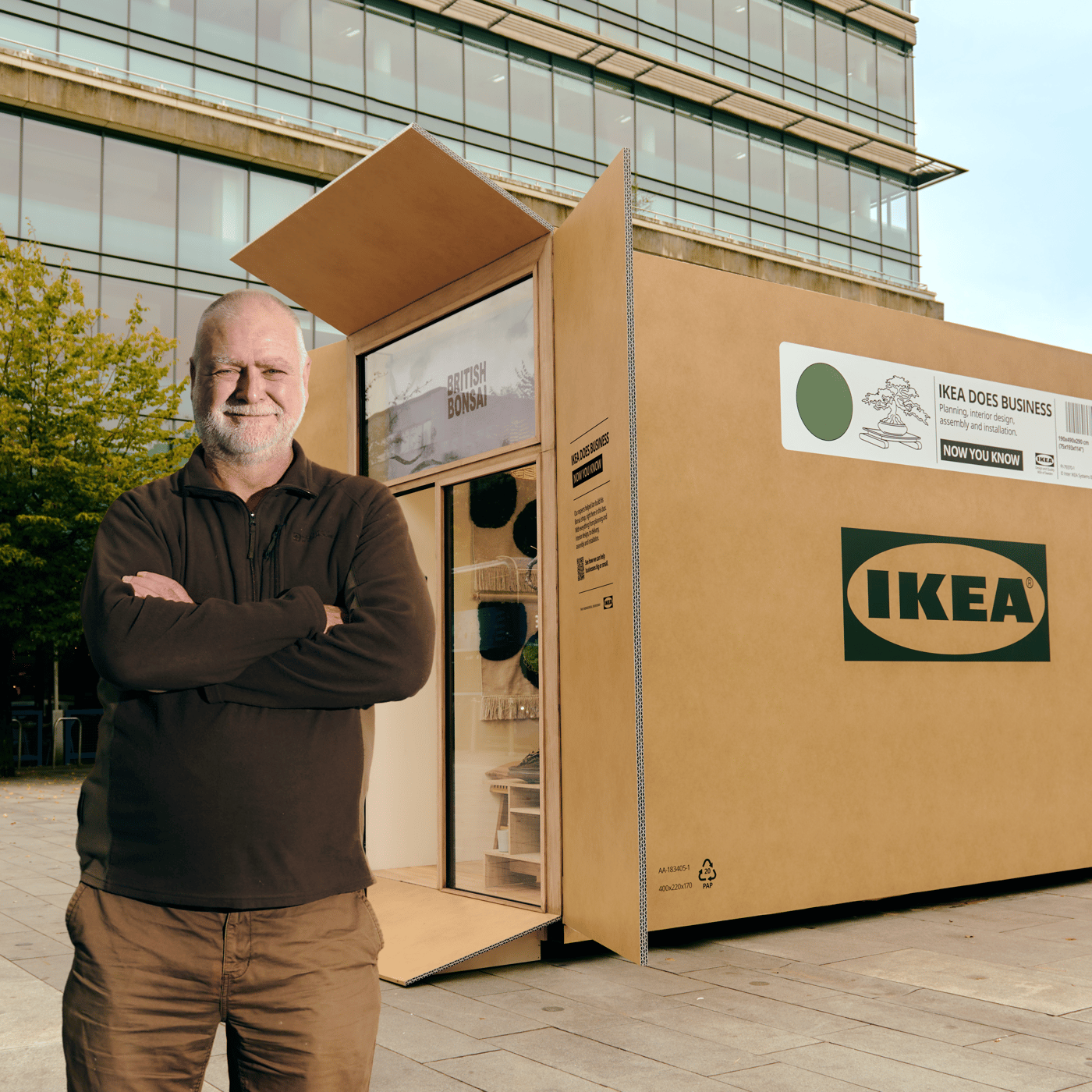A man standing in front of an IKEA giant flatpack box