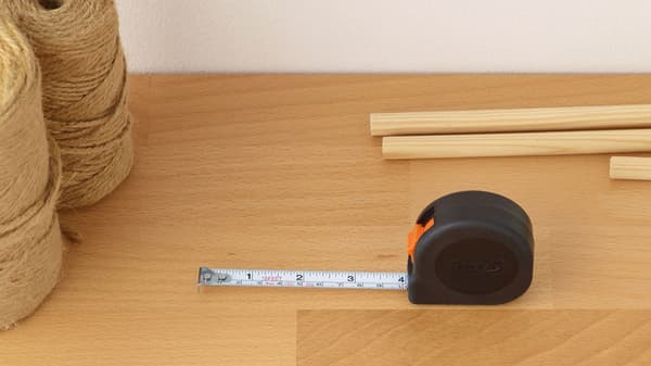 A measuring tape placed on a wooden surface.