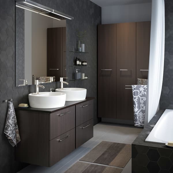A medium-sized grey bathroom with GODMORGON high and low wall bathroom cabinets in black-brown, with chrome-plated handles.