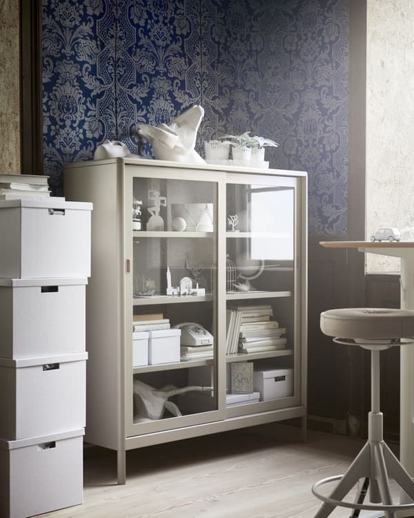 A metal office cabinet in beige with glass doors