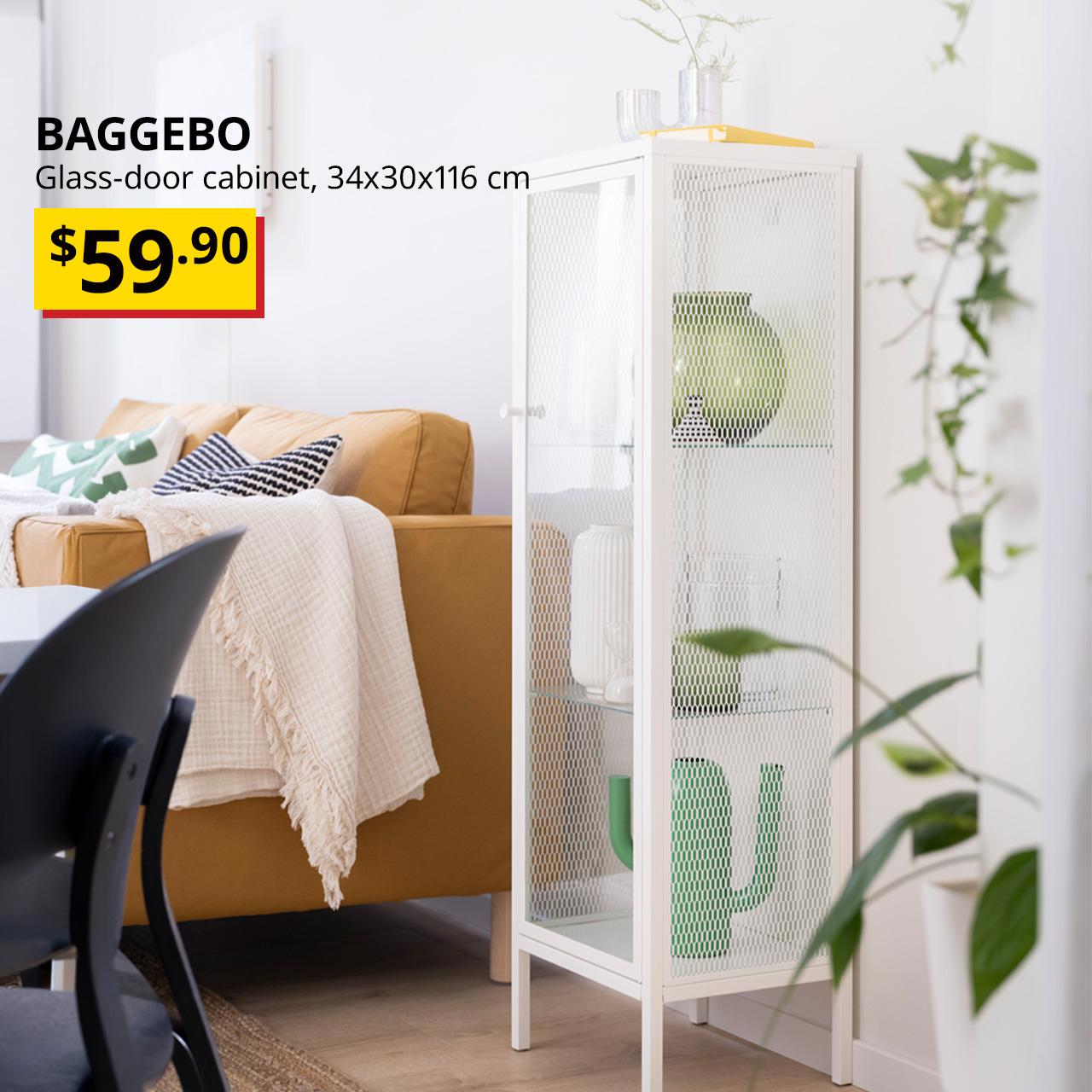 A metal white BAGGEBO glass-door cabinet in a living room setting next to a sofa with decorations displayed on each shelving. Black text overlay image on the left that reads , "BAGGEBO, Glass-door cabinet, 34x30x116 cm" with BTI Price: $59.90.