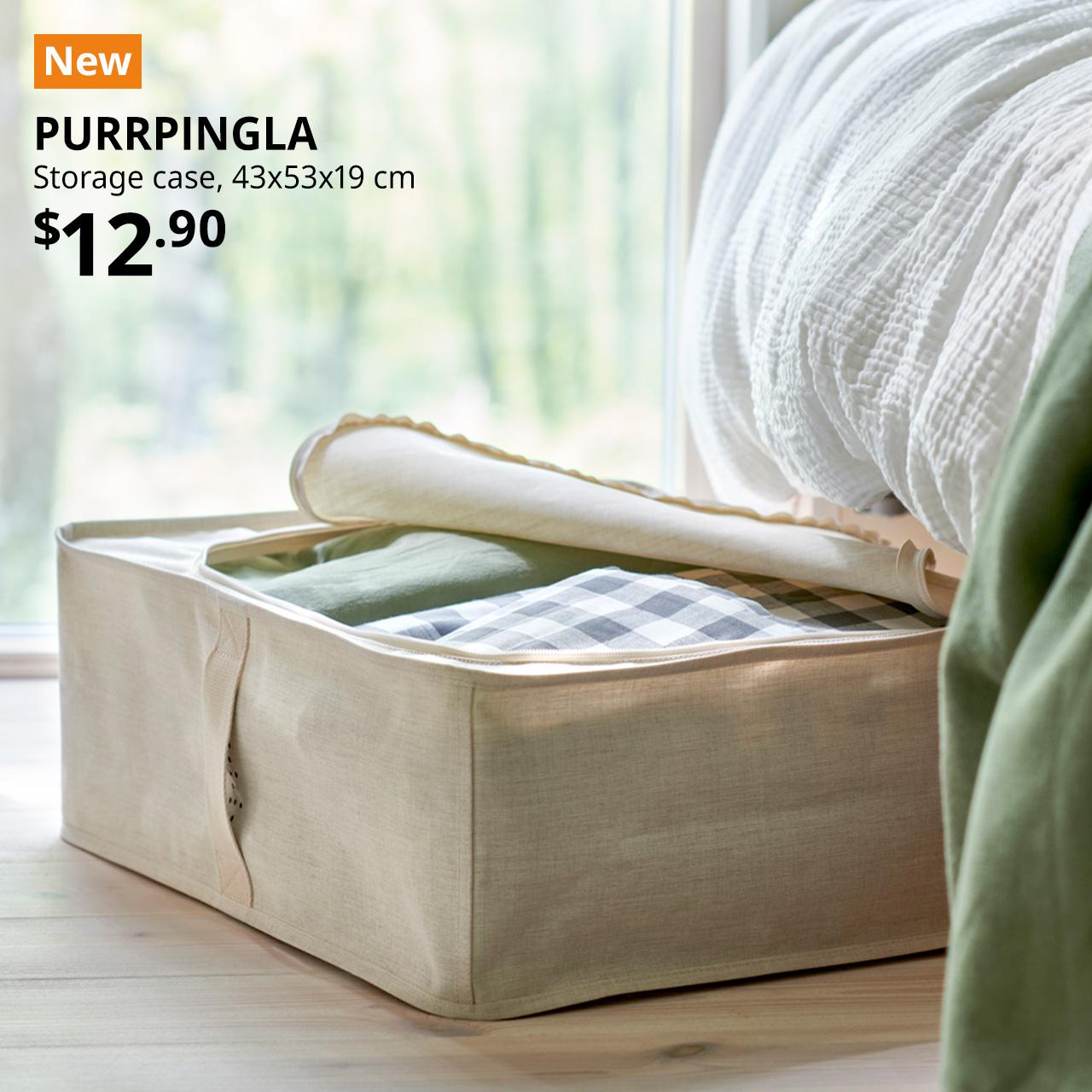 A mid-shot of a beige textile PURRPINGLA storage case is utilised to store bed textiles. Orange tag with white text that reads "New". Black text overlay image that reads "PURRPINGLA, Storage case, 43x53x19 cm. Price at $12.90."