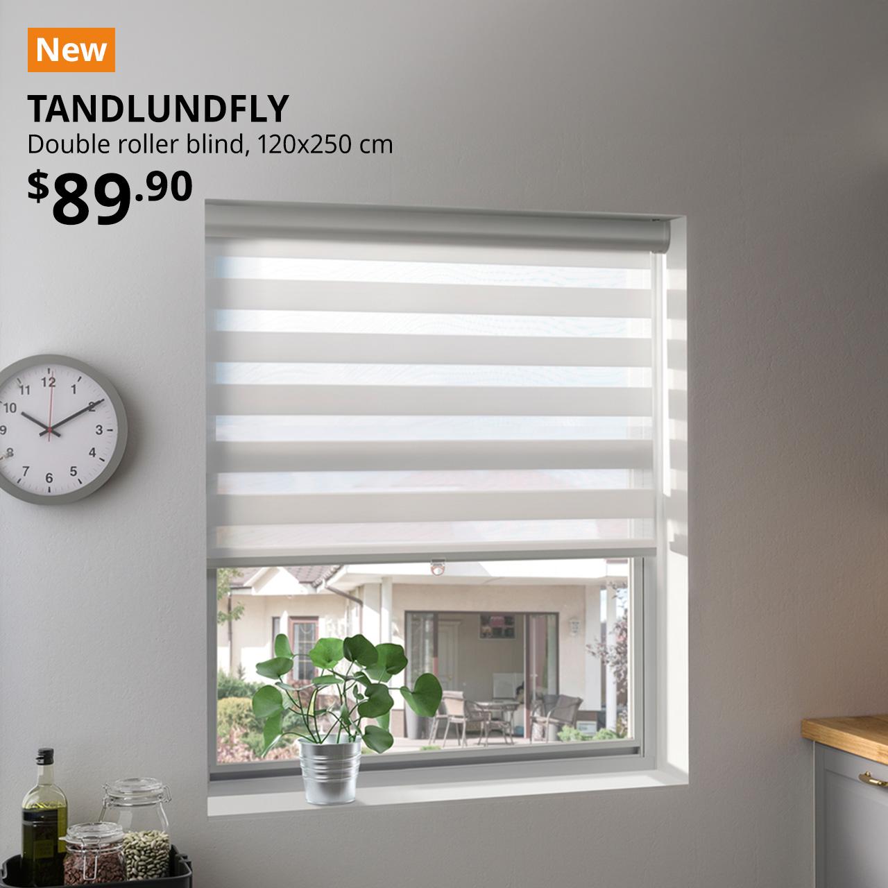 A mid shot of a kitchen window using a white TANDLUNDFLY double roller blind. An orange tag with white text that reads, "New". Followed by black text overlay image that reads, "TANDLUNDFLY, Double roller blind, 120x250 cm, $89.90".