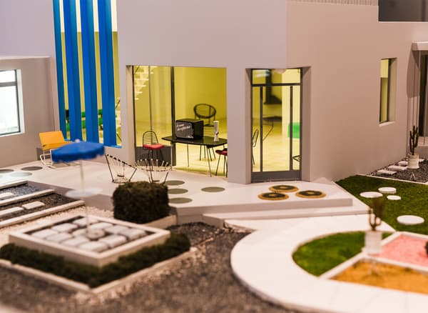 A miniature model of a home and outdoor space.