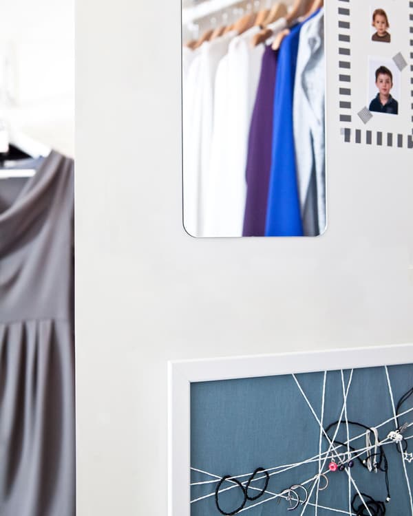 A mirror and board to create a vertical dressing room.