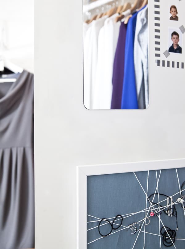 A mirror and pinboard on a wall.