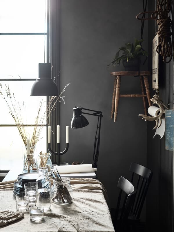 A mix of seating at a modern rustic dining table with classic Swedish chairs and cork stools