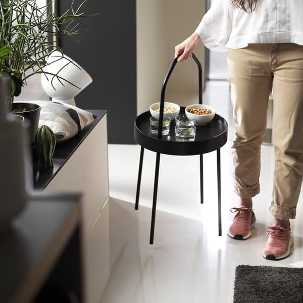 A mobile and lightweight side table that you easily can carry with one hand, meet IKEA BURVIK black side table!
