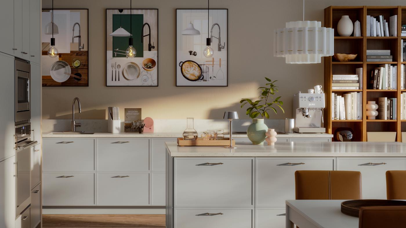 A model kitchen with light grey cabinets and built-in appliances. We see a central island, and part of a dining table.