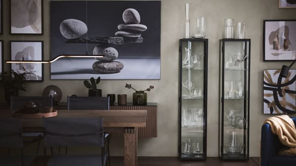 A modern dining room with large paintings on wall