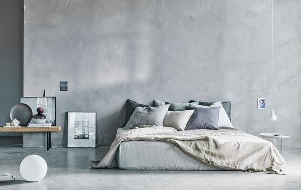 A modern, natural coloured, airy bedroom space.