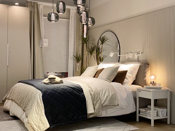 A modern, stylish bedroom with lots of beige and a large double bed in the middle