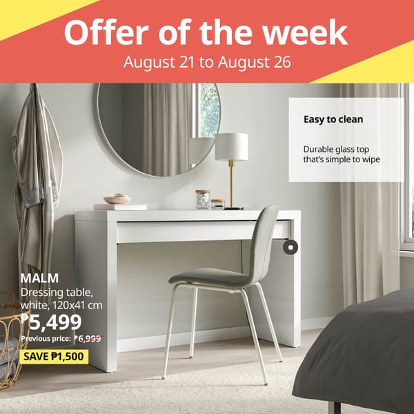 A modern white MALM dressing table with a circular mirror, styled with a gray chair, showcasing a 1,500 peso discount offer.