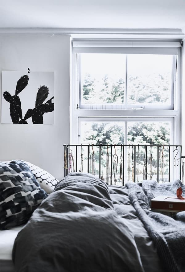 A monochrome bedroom with grey bedding.