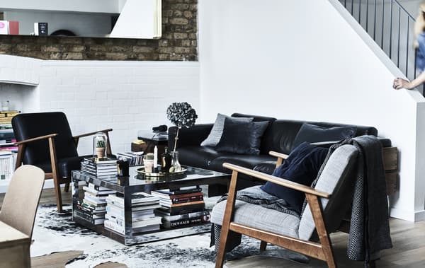 A monochrome living room with two IKEA armchairs.
