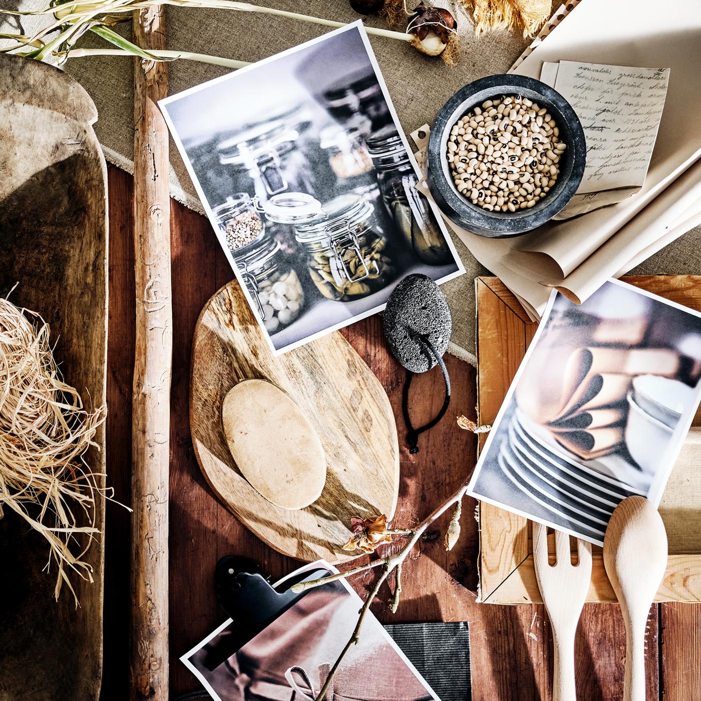A mood board including a marble ÄDELSTEN pestle/mortar, an acacia FASCINERA chopping board and a beech RÖRT fork and spoon.