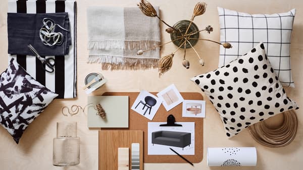A mood board laid out with images of furniture, cushions, two KONSTFULL glass vases, fabrics and other samples of materials.