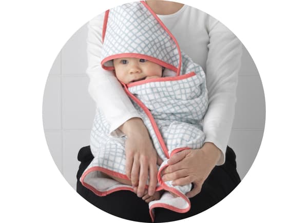 A mum with her baby, dressed in IKEA textiles that are tested thoroughly for the safety of children.