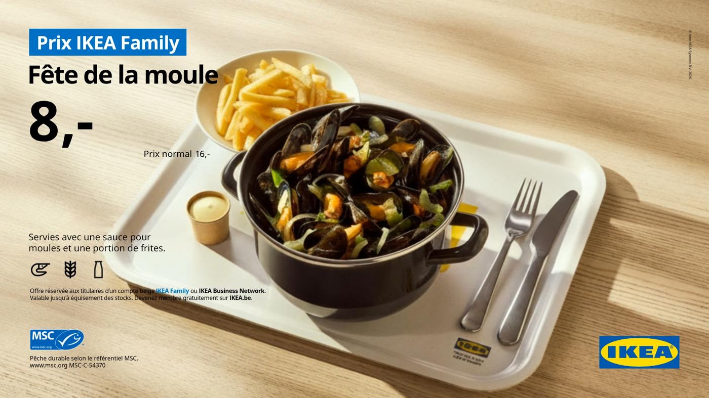 A mussel dish with fries and drink.