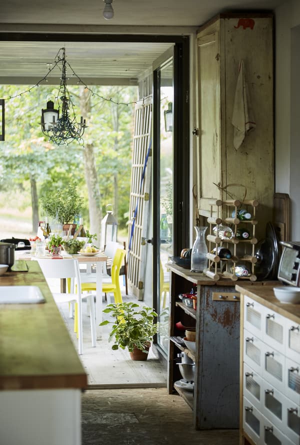 A narrow kitchen leading to the dining table.