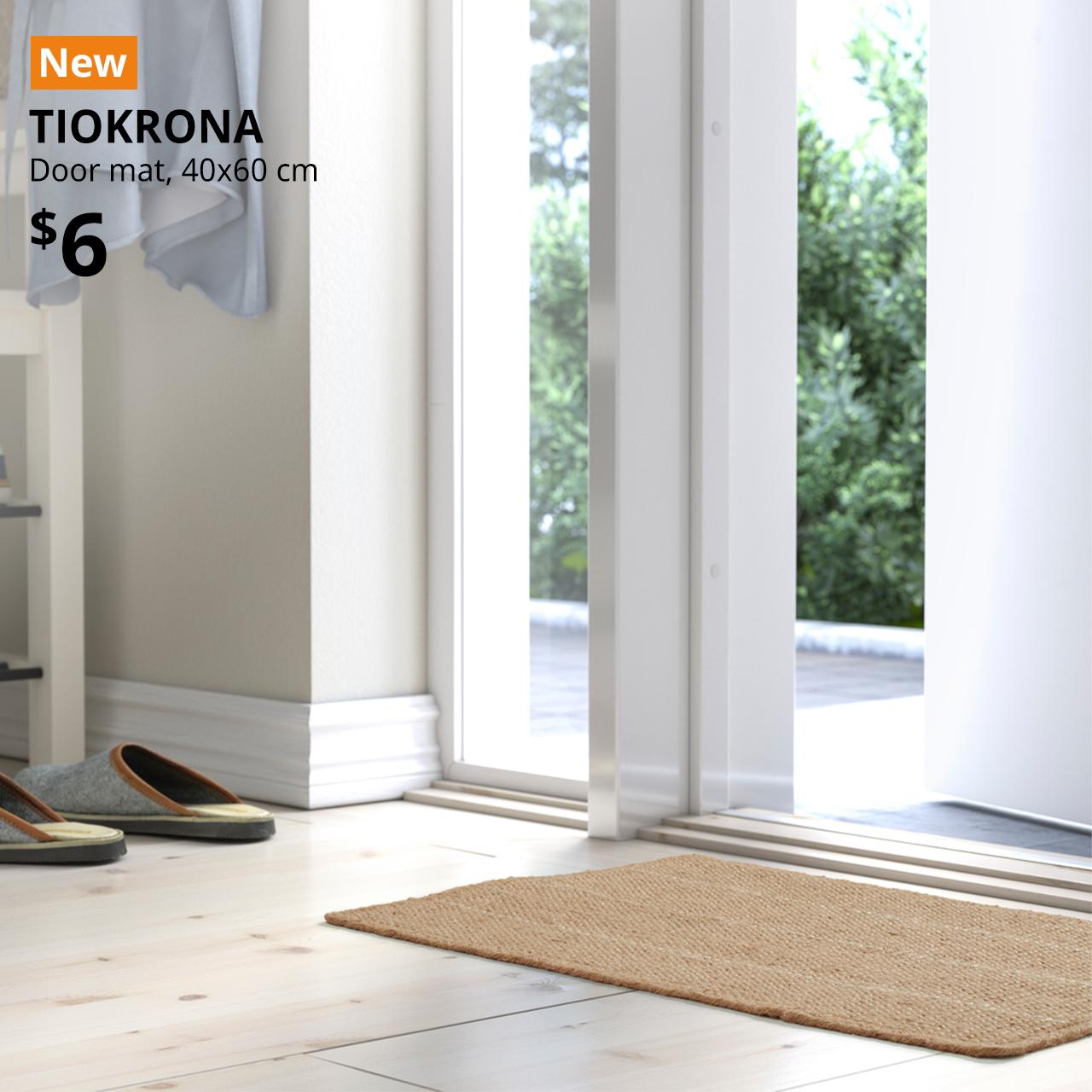 A natural cooured TIOKRONA door mat is at the main entrance. An orange "NEW" label is on the top left of the image with black text that reads: TIOKRONA, door mat. $6