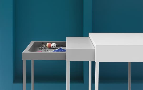 A nest of three tables with a tray in the top of the smallest table.