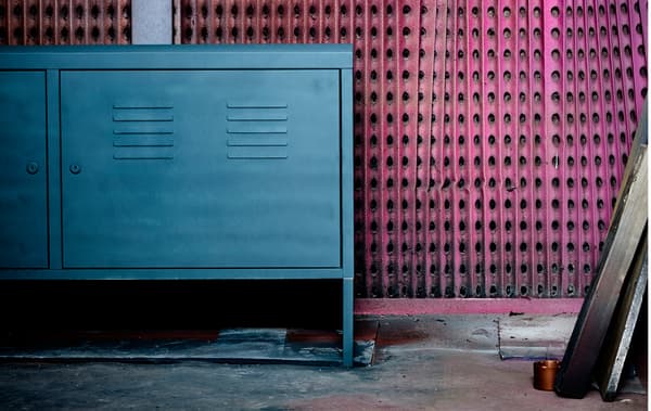A newly madeover metal cabinet sits against a graphically painted wall.