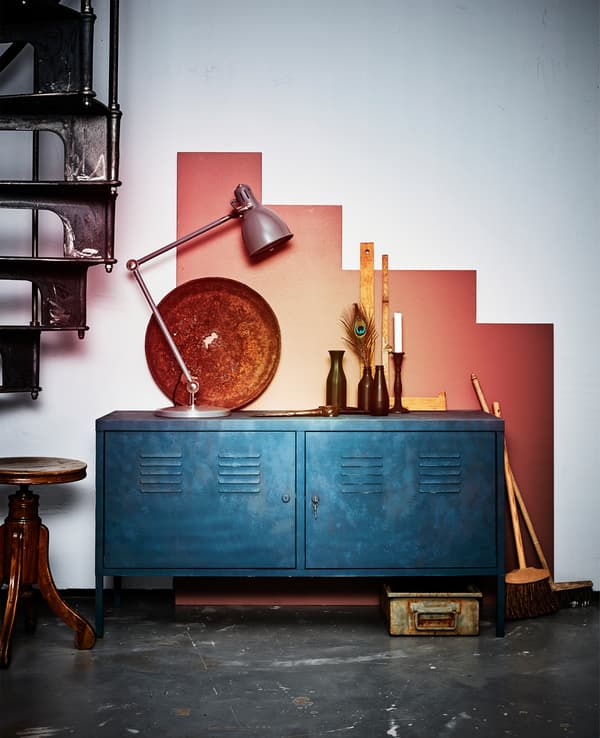 A newly madeover metal cabinet sits against a graphically painted wall.