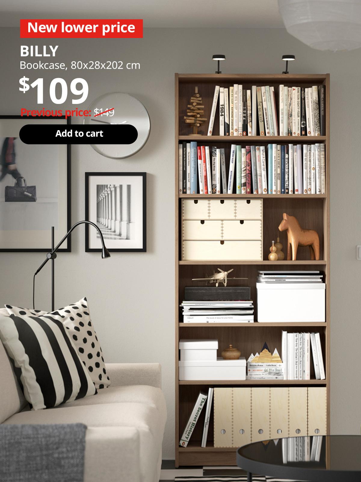 A oak effect BILLY bookcase fill with books in a living room setting. Red 'Lower price' tag with white font on top left of image. White text reads "BILLY, Bookcase, $109." With previous price of $149 slashed.
